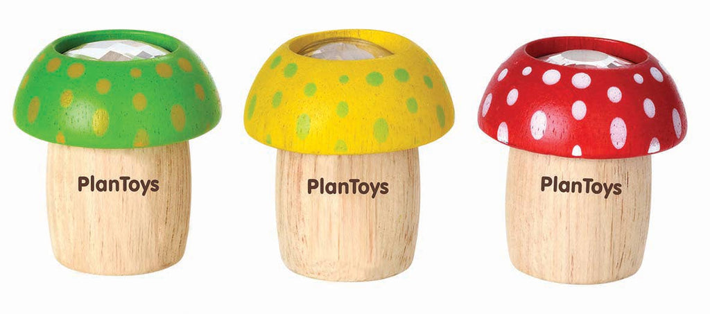 Three Mushroom Kaleidoscope with differently colored caps and spots, each designed to explore creative thinking skills and featuring the PlanToys logo on their stems.
