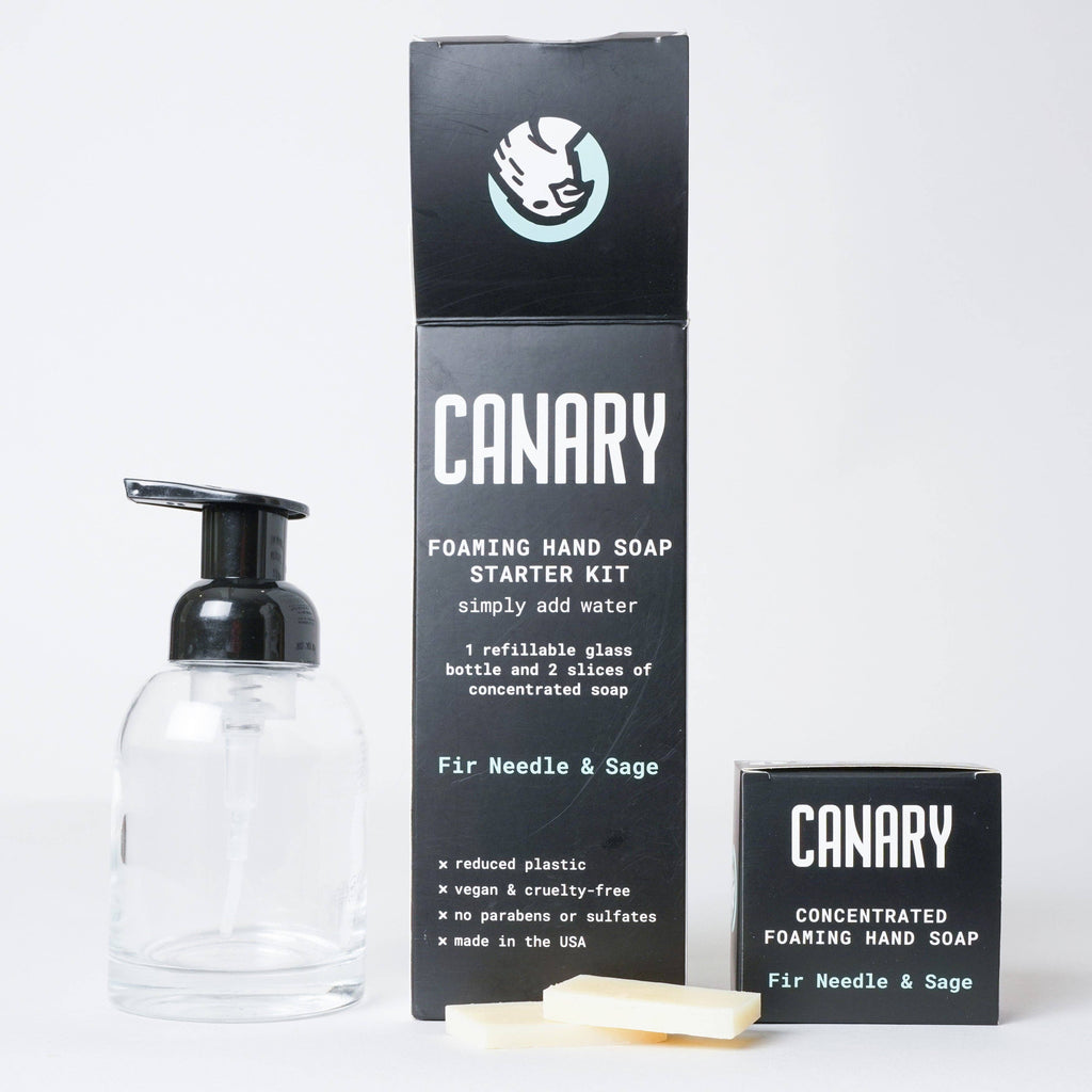 A Canary Clean Products concentrated foaming hand soap starter kit, including a refillable glass bottle and two sachets of Fir Needle + Sage soap, displayed against a plain background.
