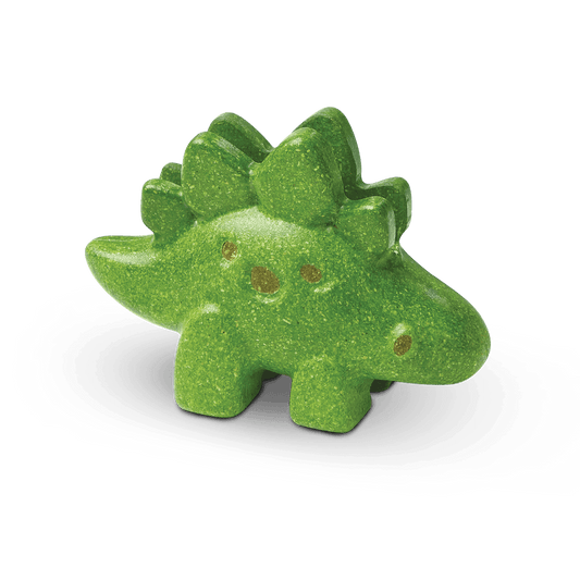 A green, PlanToys - Stegosaurus-shaped bath bomb with glitter on a dark background, perfect for creative playtime.