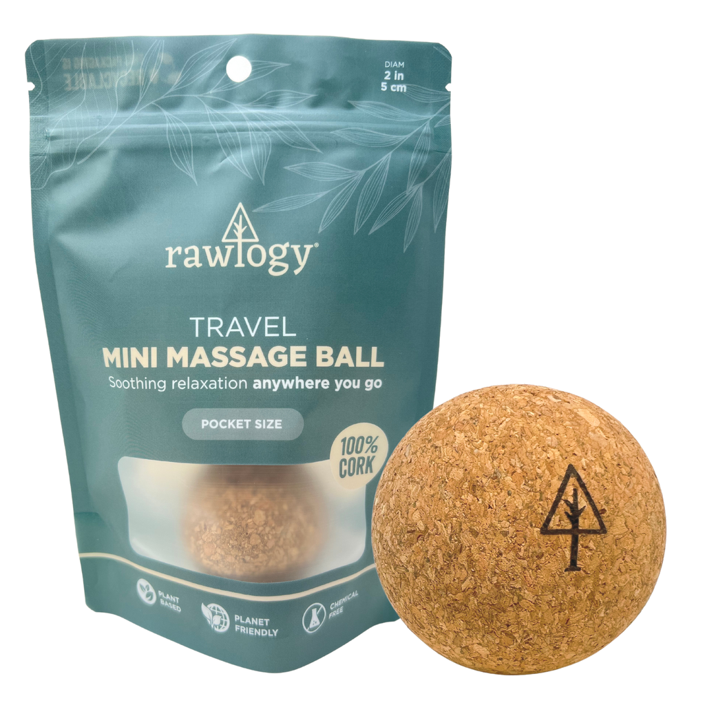 A small round brown Rawlogy® Cork Massage Ball | Mini (1.9") next to a small brown bag.